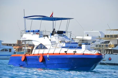 Family enjoying a private boat trip with fishing, snorkeling, island hopping, and lunch in Hurghada